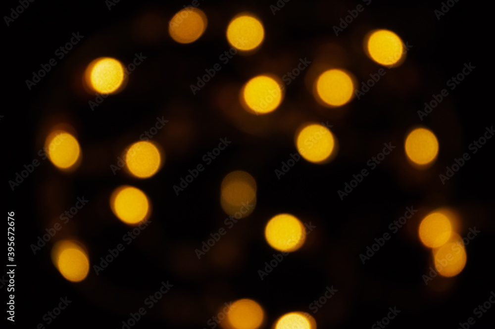 Defocused gold small bokeh on a black background. abstract background. Christmas bokeh yellow. Defocused gold small bokeh on a black background. abstract background. Christmas bokeh yellow.