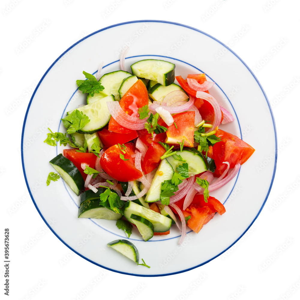 Vegetable salad with fresh tomatoes, cucumbers, sliced onion and olive oil. Isolated over white background