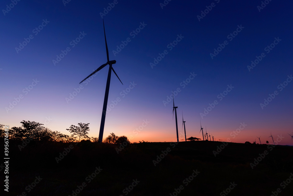 Obraz premium wind turbines park for make the electric power from wind in sunrise time