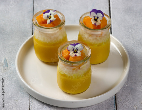 Royalty-free stock photo ID: 1785693371Mango sago. Healthy tapioca pearls pudding dessert with coconut milk and mango garnish with edible flower.