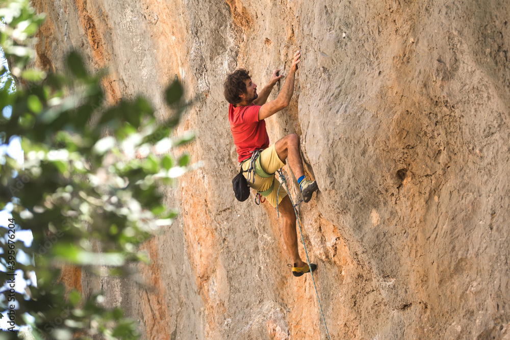 A climber is training on a natural terrain. A climber is training on a natural terrain.