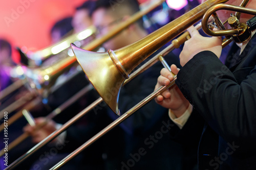 Detail of a trombone in the hands of the musician closeup