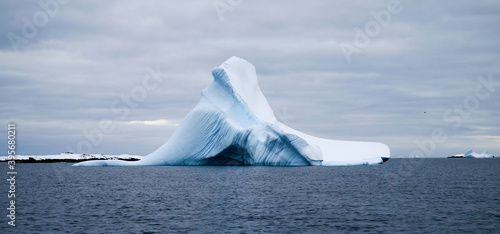 Icebergs and snow capped mountains in the Antarctic Peninsula after passing the Lemaire Channel in Antarctica.