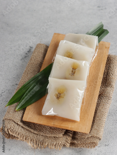 Nagasari, Indonesian traditional steamed snack made from hunkwe flour, coconut milk and sugar. Filled with sliced of banana photo