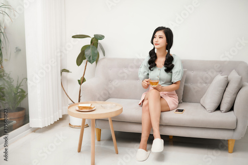 smile young woman holding cup of green tea at home, healthy lifestyle concept, asian beauty, © makistock