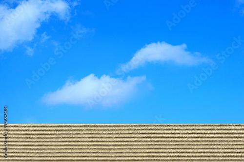 Beautiful sand beach on blue sky and cloudy background. Montage to show your product. Copy space. Summer time. Business or travel concept.