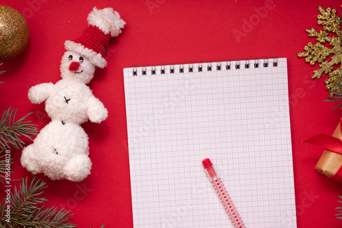 christmas message to santa claus on festive background with stars, New Year's mood, snowman made of yarn notebook and pen