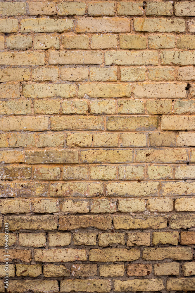 A wall of old yellow and brown bricks. A wall of old yellow and brown bricks.