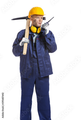Miner man with pick axe and two-way radio on white background © Pixel-Shot