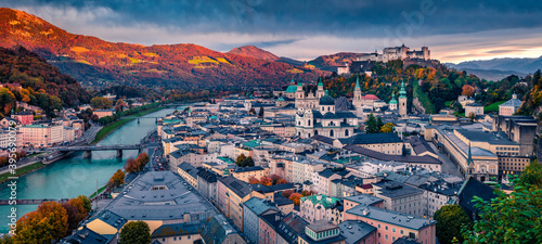 Rainy cloud under old town of Salzburg city, birthplace of famed composer Mozart. Panoramic autumn view of Eastern Alps. Dramatic landscape with Salzach river. Traveling concept background.