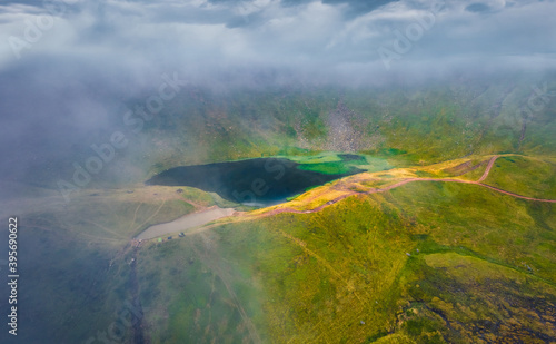 Aerial landscape photography. Foggy summer scene of popular tourist destination - Dohaska lake. Stunning morning view from flying drone of Carpathian mountains, Ukraine, Europe.