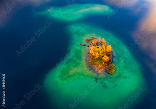 Aerial landscape photography. Stright down view from flying droneof small islet on Eibsee lake. Spectacular autumn scene of Bavarian Alps, Germany, Europe. Beautiful autumn scenery. photo