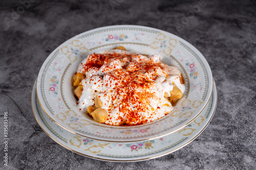 Turkish manti on plate with yogurt  sauce  red pepper  mint.