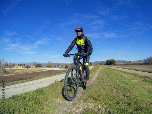 A mountain biker on the Giacomo Puccini cycle path along Serchio river
