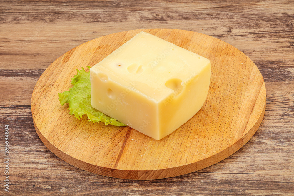 Emmental cheese over wooden board