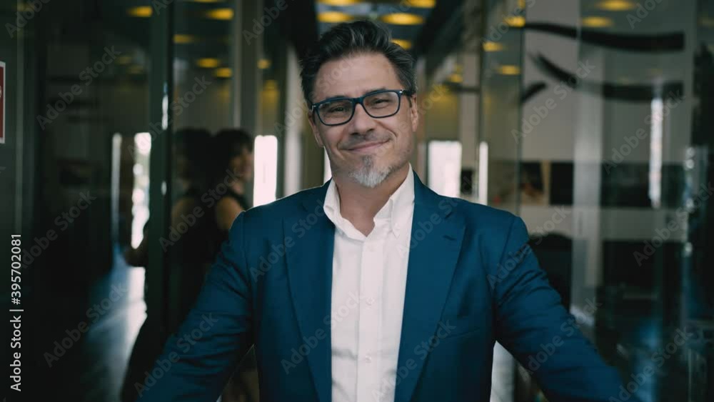 Business portrait - happy confident successful businessman in corporate office. Colleagues at workplace celebrating success. Business portrait - happy confident successful businessman in corporate office. Colleagues at workplace celebrating success.
