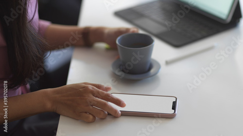 Female using smartphone while take a coffee break in meeting room