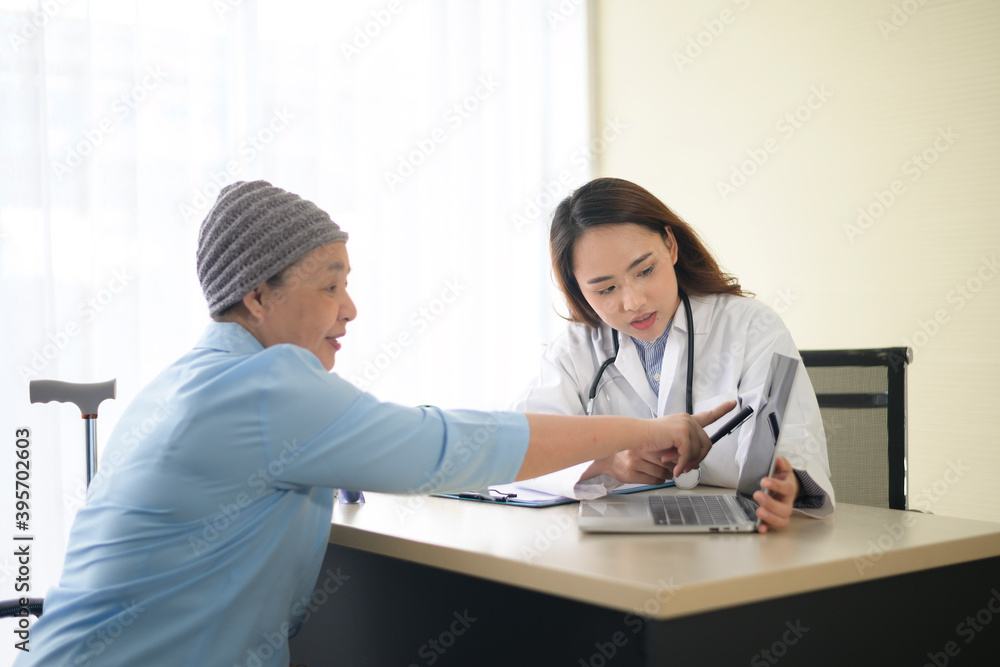 Cancer patient woman wearing head scarf after chemotherapy consulting and visiting doctor in hospital. Cancer patient woman wearing head scarf after chemotherapy consulting and visiting doctor in hospital.