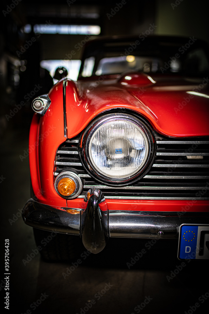 Headlight  of a red vintage classic oldtimer