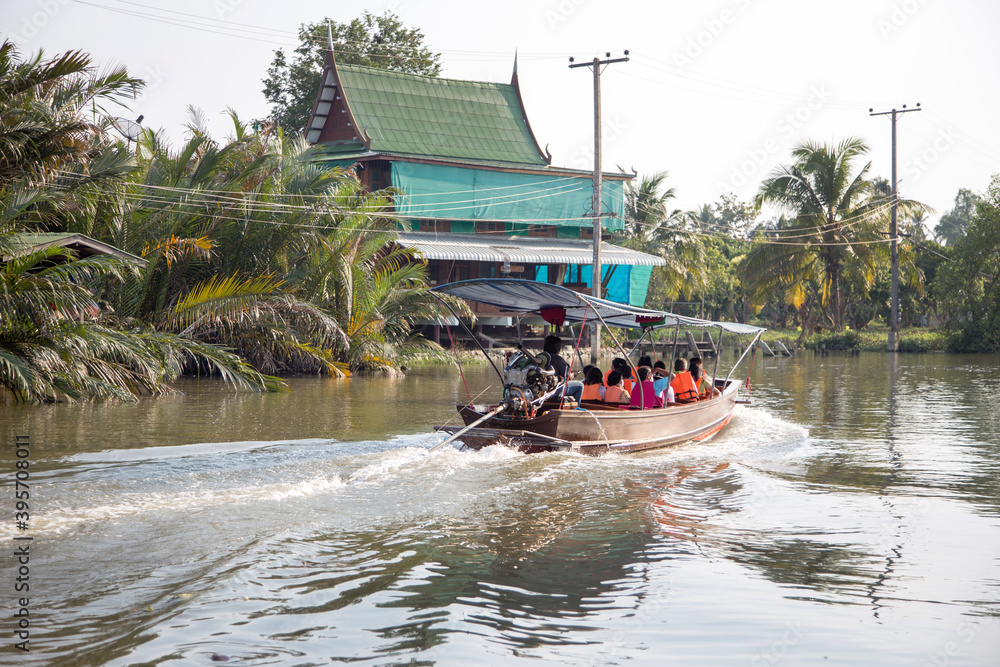 Fototapeta premium tourism people seeing riverside lifestyle on wood boat passenger