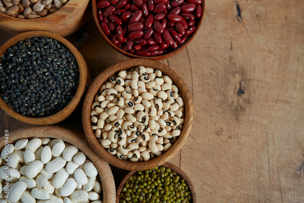 assortment of beans on wooden surface assortment of beans on wooden surface