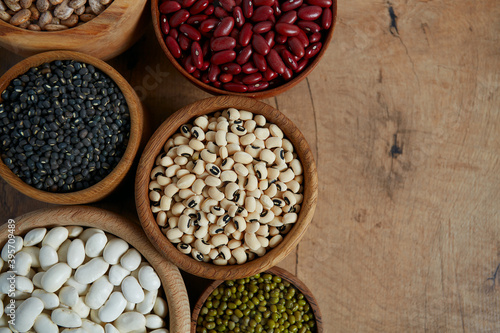 assortment of beans on wooden surface