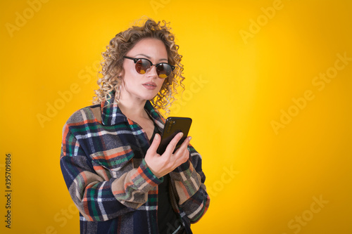 curly woman using smartphone