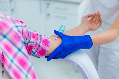 Medical worker adjusting vein catheter close up image