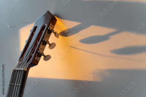 detalle de clavijero de guitarra española al atardecer photo