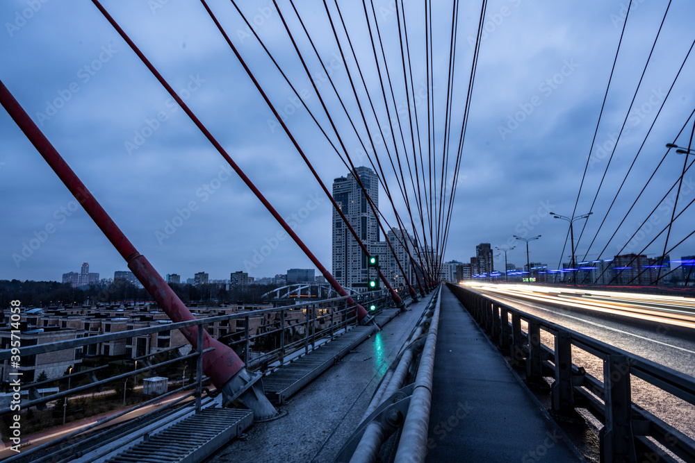 Obraz premium red cable-stayed bridge and freeway at sunrise on winter morning