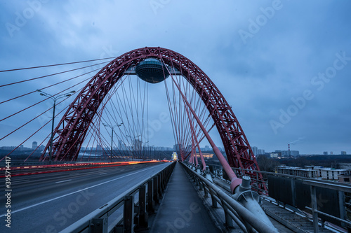 red cable-stayed bridge and freeway at sunrise on winter morning © константин константи