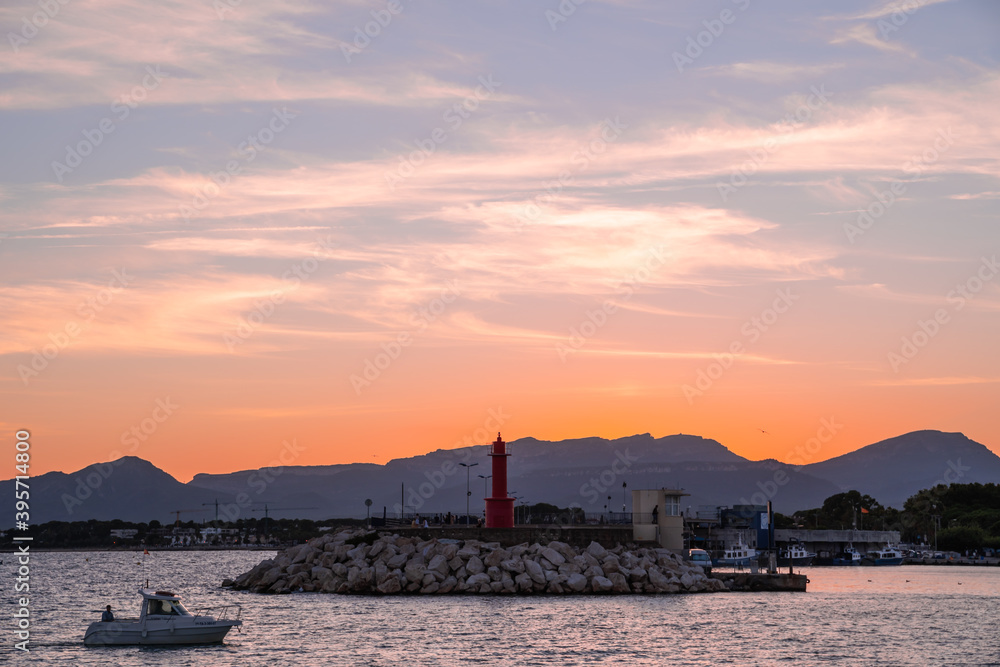 puesta de sol sobre el faro del puerto de cambrils, tarragona puesta de sol sobre el faro del puerto de cambrils, tarragona