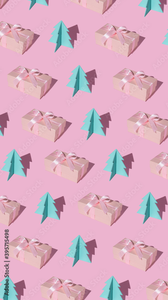 Creative Christmas pattern made of gift box and paper pine tree and trend shadows on pastel pink background. Minimal December New Year concept. Flat lay. Creative Christmas pattern made of gift box and paper pine tree and trend shadows on pastel pink background. Minimal December New Year concept. Flat lay.