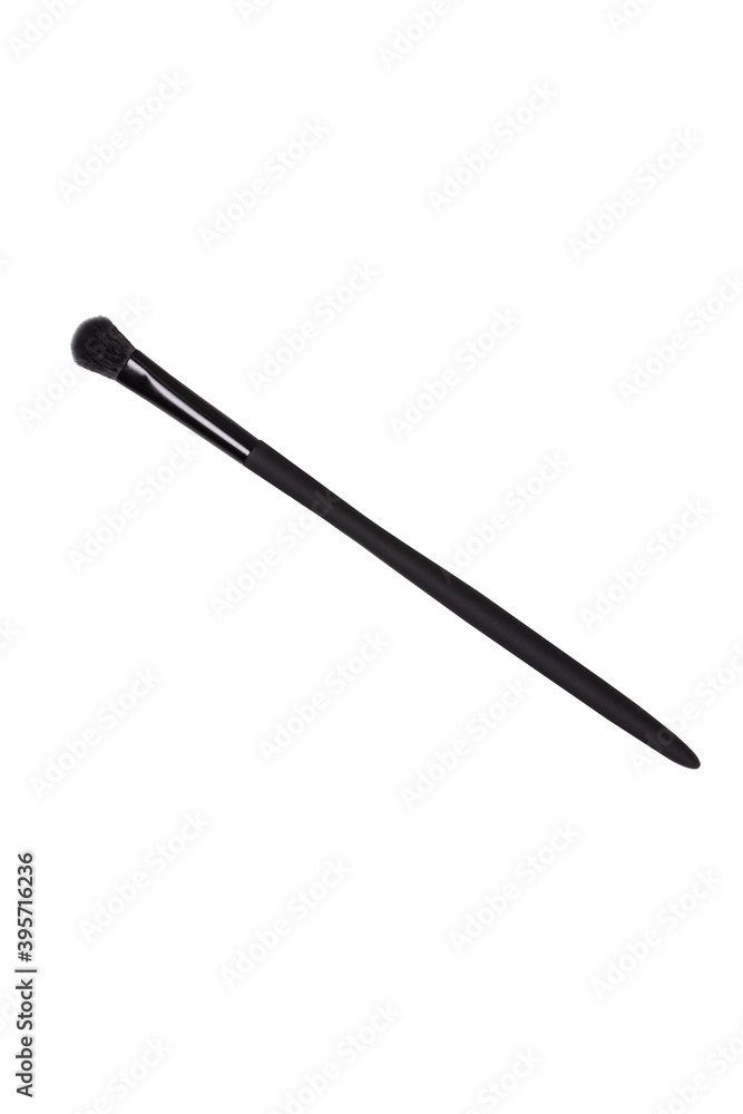 Selective focus on a elegant black clean professional makeup brush isolated on a white background. Concept beauty. Macro. Selective focus on a elegant black clean professional makeup brush isolated on a white background. Concept beauty. Macro.