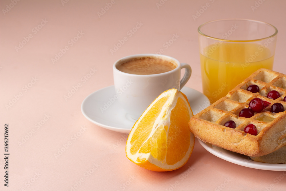 waffles with honey and berries black coffee for breakfast on a pink background. waffles with honey and berries black coffee for breakfast on a pink background.