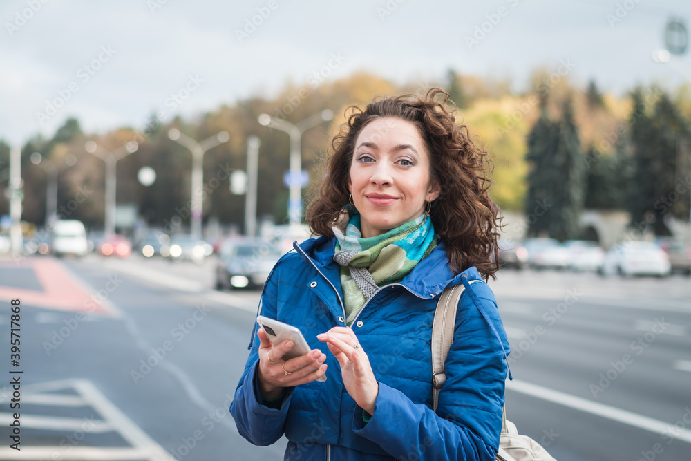 Fototapeta premium Girl student in a blue jacket on the street