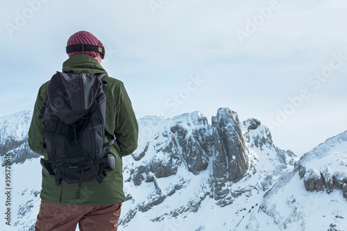 A skier enjoying the snowy mountains view from the high lookout. France.