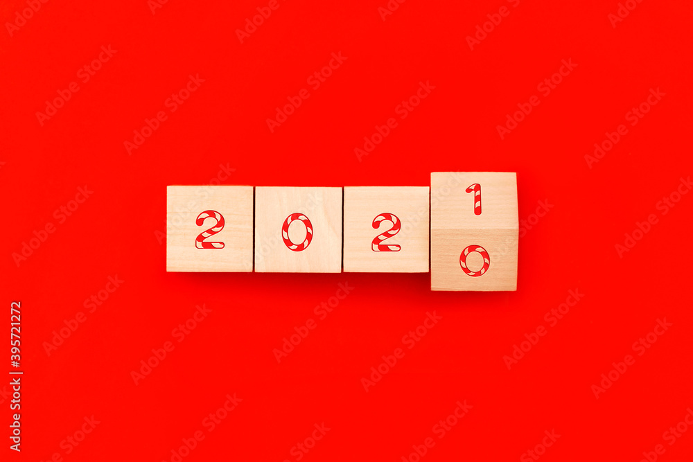 Wooden cubes block to change 2020 to 2021 year on red background. Merry Christmas and happy new year concept. Wooden cubes block to change 2020 to 2021 year on red background. Merry Christmas and happy new year concept.