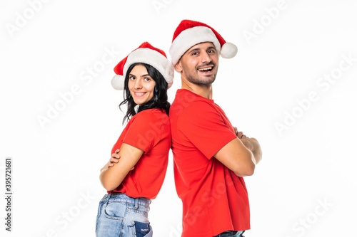 Young happy couple in Christmas hats isolated over white background