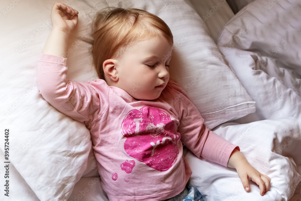 Child little girl sleeping in bed. Morning time Child little girl sleeping in bed. Morning time