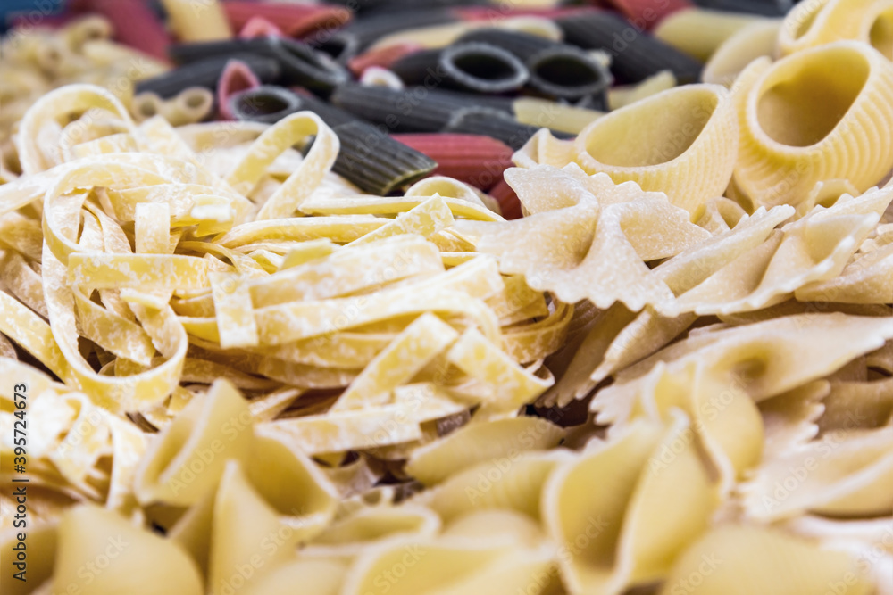various varieties and types of pasta made from coarse flour. Assorted pasta background