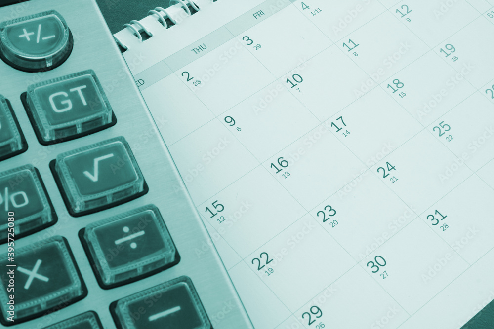 Accounting concept, calculator on calendar background Accounting concept, calculator on calendar background