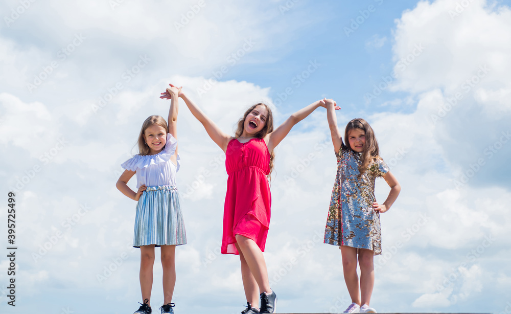 we are one. beautiful teen girls holding hands. kid fashion style. female friendship and sisterhood. happy childhood. cute children on sky background. beauty. summer fashionable look we are one. beautiful teen girls holding hands. kid fashion style. female friendship and sisterhood. happy childhood. cute children on sky background. beauty. summer fashionable look