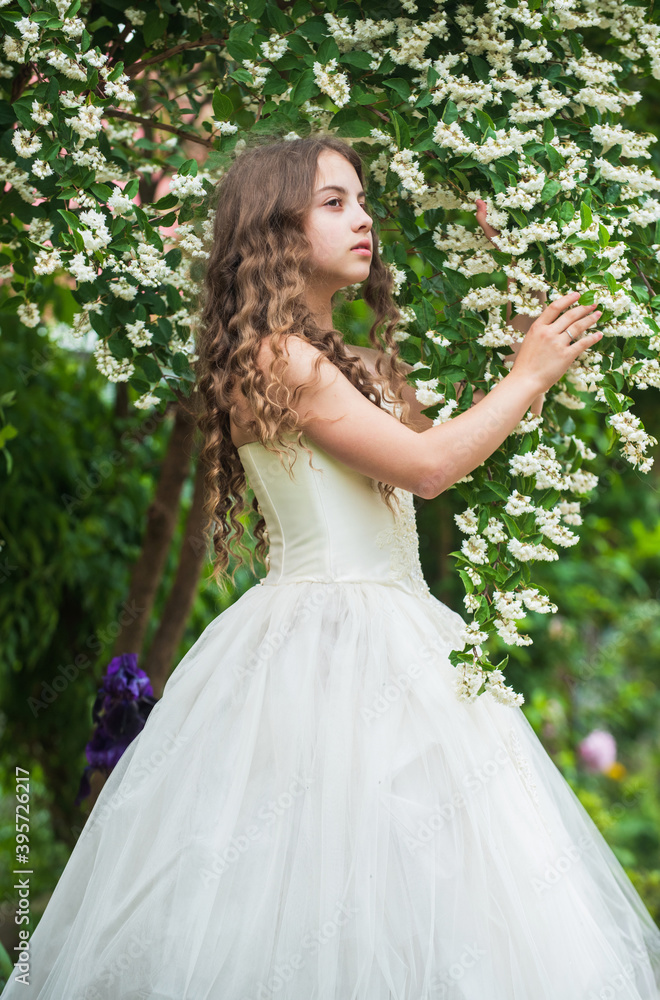 Moment of happiness. female fashion salon. little beauty in blossoming garden. park jasmine flower. beautiful prom queen. look as princess. bridesmaid. childhood happiness. girls party dress Moment of happiness. female fashion salon. little beauty in blossoming garden. park jasmine flower. beautiful prom queen. look as princess. bridesmaid. childhood happiness. girls party dress