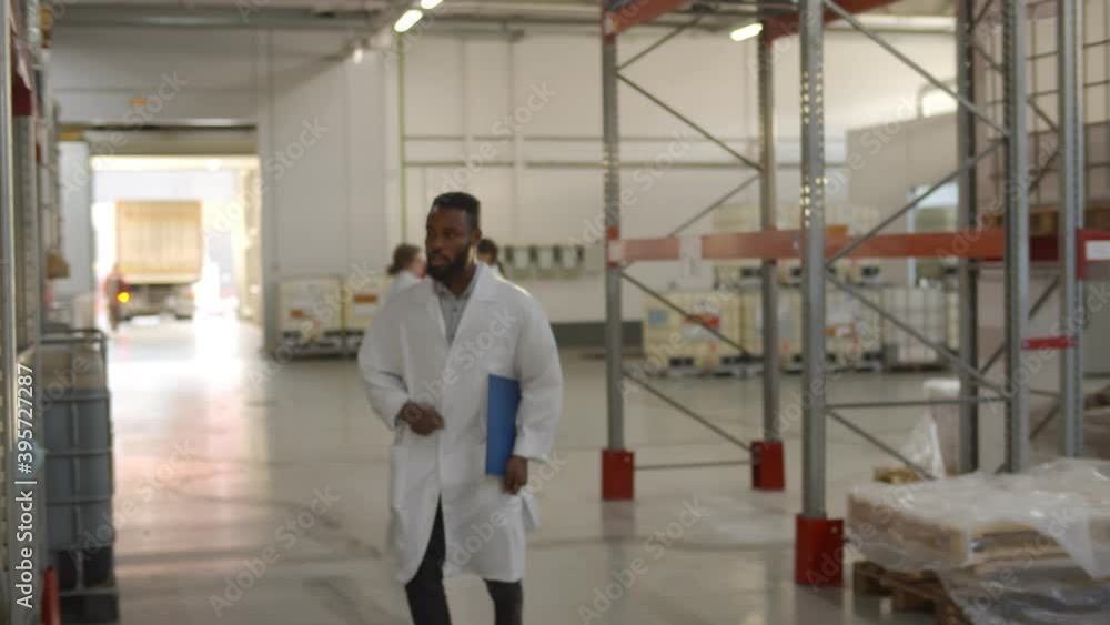 Happy african factory engineer dancing and smiling walking in warehouse Happy african factory engineer dancing and smiling walking in warehouse