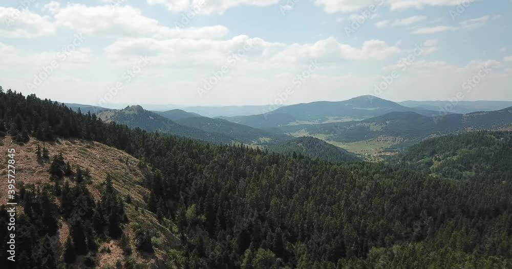Hilly surface of a mountain plateau covered with grass and forest, drone view Hilly surface of a mountain plateau covered with grass and forest, drone view