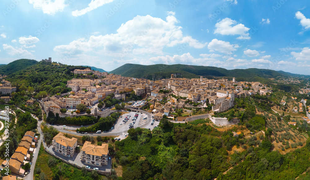 Panoramic aerial view of Narni (Terni, Umbria, Italy), medieval city with a rich history. Houses made of stone on top of the mountain. Incredible views. Summer day. Europe travel and vacation concept