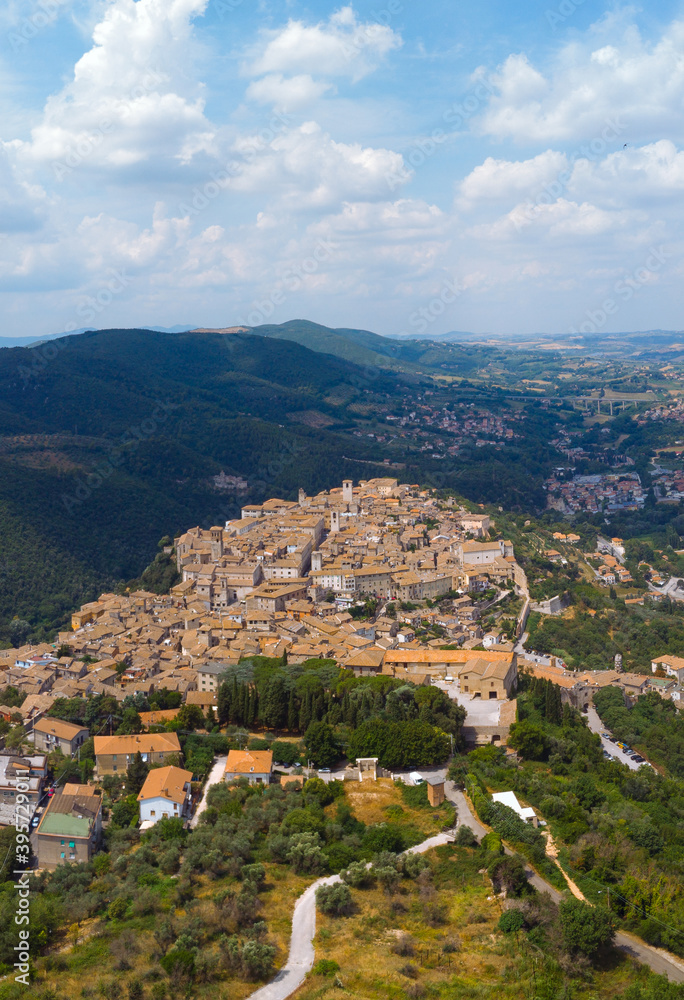 Panoramic aerial view from top of mountain of Narni (Terni, Umbria, Italy), medieval city. Houses made of stone. Incredible views. Vertical photo. Europe travel and vacation concept