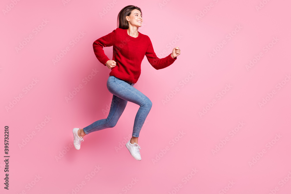 Full length body size portrait of nice girl jumping high wearing casual outfit smiling running fast isolated on pink color background