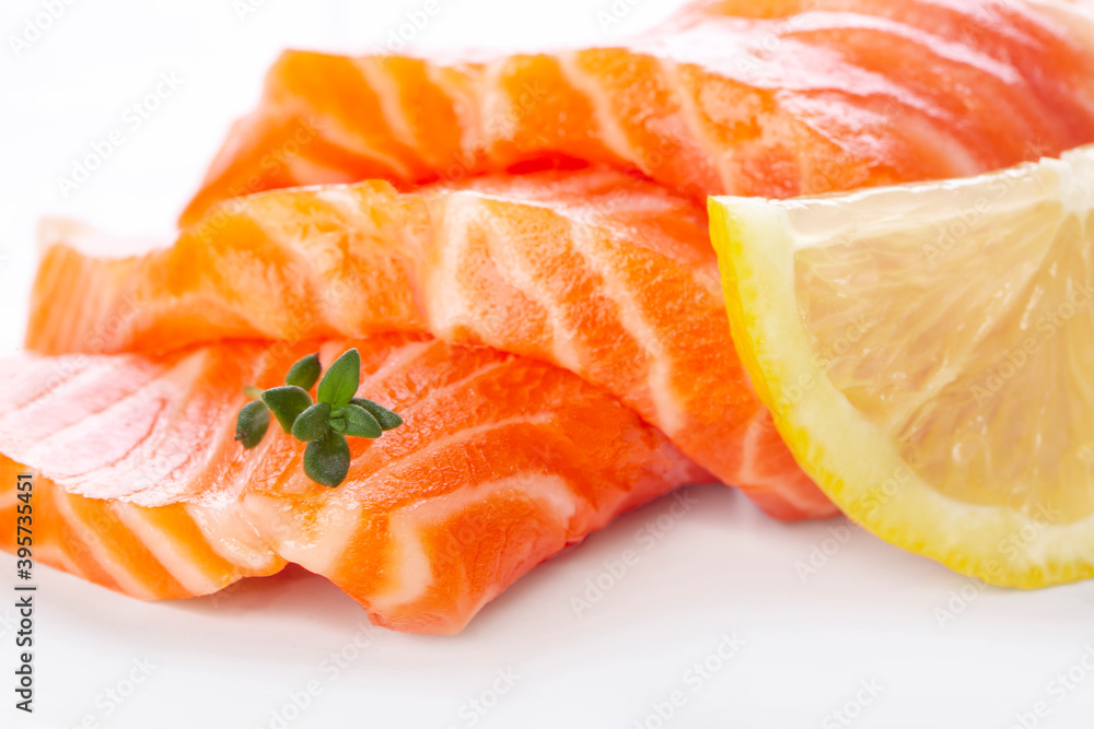 Fresh salmon sashimi slices and lemon